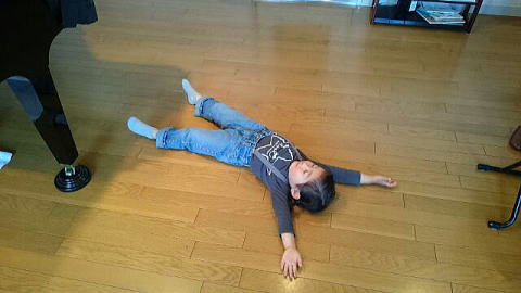 床で寝そべる４才の生徒